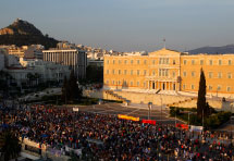 Protesters stand in front of the Greek parliament (Reuters/Yannis Behrakis)