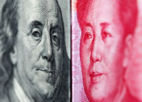 A 100 yuan banknote is placed beside a U.S. 100 dollar banknote(Reuters/Nicky Loh)