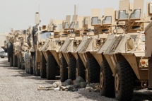 US soldiers rest in the shade of armoured vehicles at a courtyard at Camp Liberty in Baghdad.(REUTERS/Mohammed Ameen)