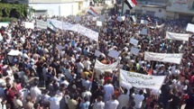 Demonstrators protesting against Syria's President Bashar al-Assad march through the streets after Friday prayers in Hula, near Homs. (REUTERS/Handout)