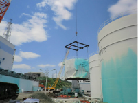 Heavy Oil Tank No.1 is removed by a crane at Tokyo Electric Power Co. (TEPCO)'s Fukushima Daiichi Nuclear Power Station in Fukushima prefecture.(REUTERS/Ho New)