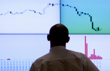 An employee looks at an electronic board at RTS stock exchange in Moscow.(REUTERS/Denis Sinyakov)