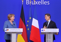 German Chancellor Angela Merkel and French President Nicolas Sarkozy hold a joint briefing at the EU summit in Brussels. (REUTERS/Thierry Roge)