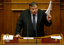 Greece's Finance minister Evangelos Venizelos raises documents as he delivers a speech during a parliament session in Athens.(REUTERS/Yiorgos Karahalis)