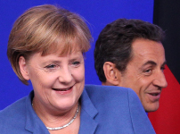 German Chancellor Angela Merkel and French President Nicolas Sarkozy arrive to hold joint briefing at the EU summit in Brussels.(REUTERS/Thierry Roge)