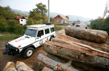 KFOR vehicle passes by a partially removed roadblock near the village  of Zupce,Serbia.(REUTERS)