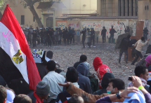 Protesters stand opposite riot police who fired tear gas during clashes between protesters and police near Tahrir Square in Cairo. (REUTERS/Asmaa Waguih)