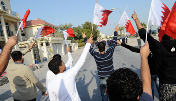 Anti-government demonstrators holding Bahraini flags during a protest. (REUTERS/Hamad I Mohammed)