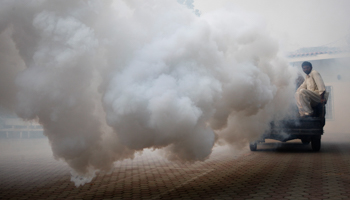 A man fumigates against mosquitoes. (REUTERS/Mohsin Raza)