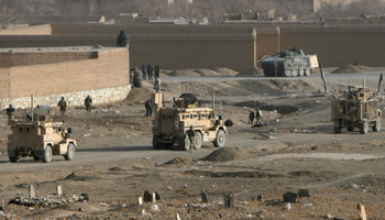 NATO troops investigate the site of a landmine in Afghanistan. (REUTERS/Mustafa Andalib)