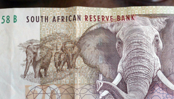 A bank teller looks at South African rand note. (REUTERS/Juda Ngwenya)