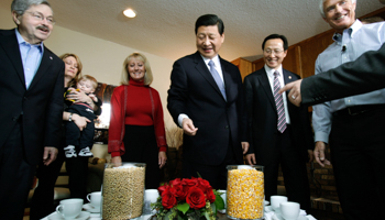 Chinese Vice President Xi Jinping looks at soybeans and corn in Iowa. (REUTERS/Handout)