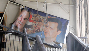 A picture of Bashar al-Assad and his father in a bombed-out police building. (REUTERS/Khaled Al Hariri)