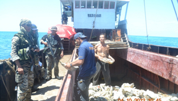 Members of Philippine Army inspect a Chinese fishing boat in the Scarborough Shoal. (REUTERS/Handout)