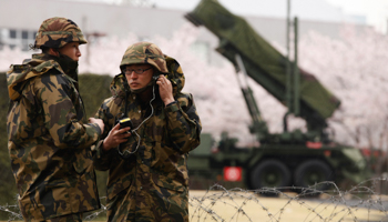 Soldiers stand guard in front of PAC-3 land-to-air missiles deployed in Tokyo. (REUTERS/Yuriko Nakao)