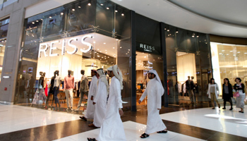 Men walk past a store in Dubai Mall shopping centre. (REUTERS/Jumana El-Heloueh)