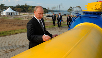 Vladimir Putin leaves his signature on a gas pipeline during its opening ceremony in Vladivostok. (REUTERS/RIA Novosti)