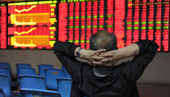 An investor watches an electronic board at a brokerage house in Hefei. (REUTERS/Jianan Yu)