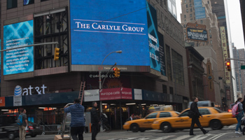 An advertisement for the Carlyle Group in New York. (REUTERS/Keith Bedford)