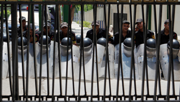 Police keep watch to prevent members of the recently scrapped parliament from entering the legislature in Cairo. (REUTERS/Asmaa Waguih)