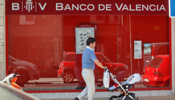 A man passes a Banco de Valencia bank branch in Madrid.(REUTERS/Andrea Comas)