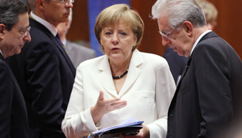 ECB President Mario Draghi and Italy's PM Mario Monti listen to German Chancellor Angela Merkel during the EU summit. (REUTERS/Francois Lenoir)