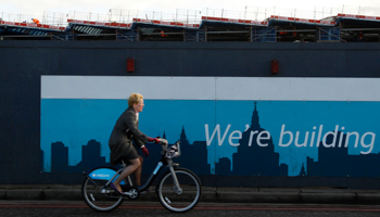 A cyclist passes a construction site at Blackfriars rail station in London. (REUTERS/Stefan Wermuth)