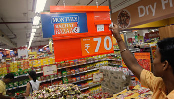 An employee changes a price tag at a retail store in Mumbai. (REUTERS/Vivek Prakash)