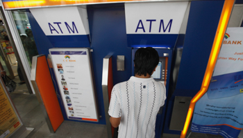 A man uses an ATM at a shopping centre in Yangon (REUTERS/Soe Zeya Tun)