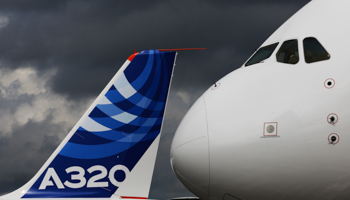 The nose cone of an Airbus A380 overlooks the tail fin of an Airbus A320 (REUTERS/Luke MacGregor)