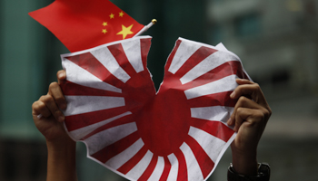 Japan's military flag is torn by a protester in Hong Kong (REUTERS/Bobby Yip)