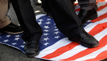 Protesters step on a US national flag during a demonstration against the Prophet Mohammed film (REUTERS/Umit Bektas)