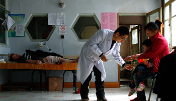 A doctor attends to a child at a rural clinic in Heilongjiang province (REUTERS/David Gray)