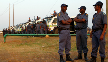 Police keep watch outside Lonmin's Marikana mine (REUTERS/Siphiwe Sibeko)