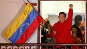 Hugo Chavez celebrates at Miraflores Palace in Caracas (REUTERS/Jorge Silva)