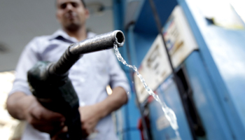 A worker holds a fuel pump nozzle at a petrol station in Cairo (REUTERS/Mohamed Abd El Ghany)