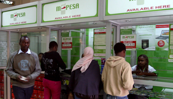 A man leaves an M-PESA booth after a money transaction in Nairobi (REUTERS/Noor Khamis)