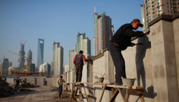 Workers build walls at a construction site in Shanghai (REUTERS/Aly Song)