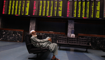 A man sits on a couch at the Karachi Stock Exchange (REUTERS/Akhtar Soomro)