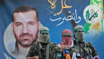Hamas militants speak with the media in Gaza City (REUTERS/Ahmed Zakot)
