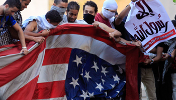 Protesters destroy a US flag in Cairo (REUTERS/Mohamed Abd El Ghany)