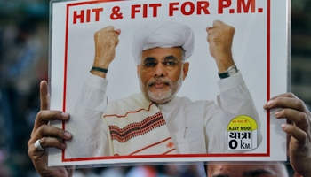 A BJP supporter holds a poster of Narendra Modi in Ahmedabad (REUTERS/Amit Dave)