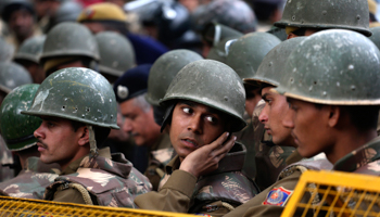 Police stand guard during a protest in New Delhi (REUTERS/Ahmad Masood)