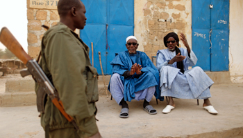 A Malian soldier talks with civilians in Timbuktu (REUTERS/Benoit Tessier)
