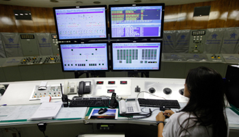 A technician works in the control room inside a hydroelectric dam (REUTERS/Paulo Whitaker)