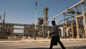 A man walks past the Mahshahr petrochemical plant in Khuzestan province (REUTERS/Raheb Homavandi)