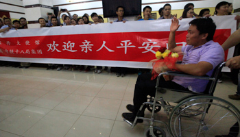 An injured Chinese worker arrives at Khartoum Airport after being released from abduction in Sudan's western Darfur last month (REUTERS/Mohamed Nureldin Abdallah)