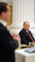 Russian President Vladimir Putin listens to Prime Minister Dmitry Medvedev (REUTERS/RIA Novosti)