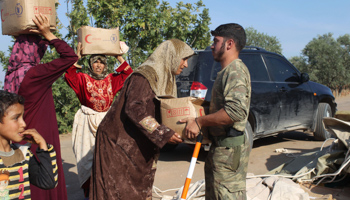 Residents receive humanitarian aid from the Free Syrian Army  (REUTERS/Asmaa Waguih)