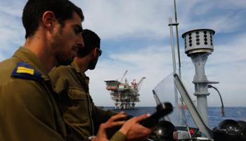 An Israeli gas platform is seen behind sailors in an Israeli navy patrol boat (REUTERS/Amir Cohen)